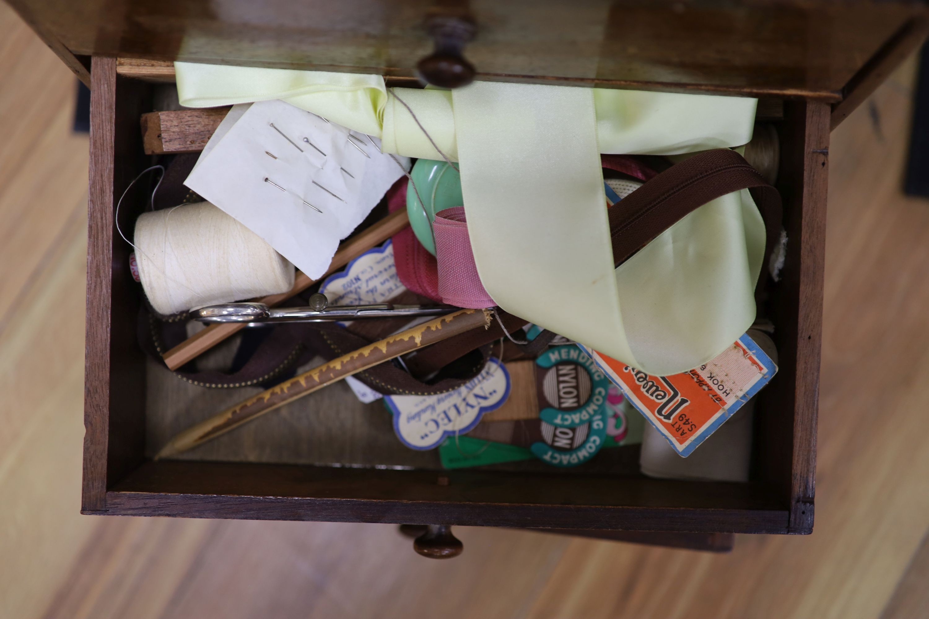 An early 20th century miniature chest and contents